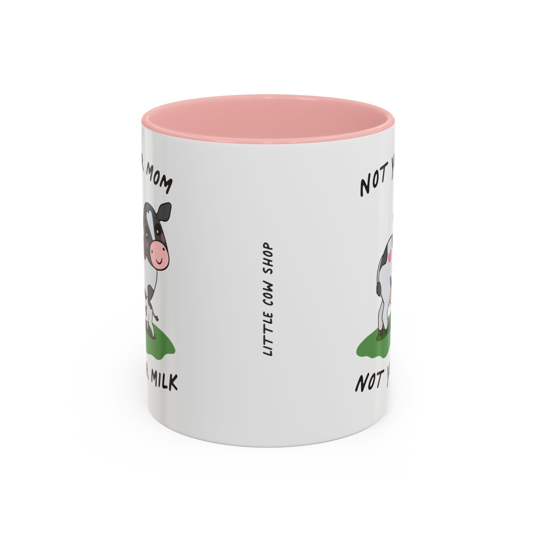 A white ceramic mug with a pink interior, featuring a cartoon cow illustration and the text 'NOT YOUR MOM, NOT YOUR MILK' and 'LITTLE COW SHOP'.
