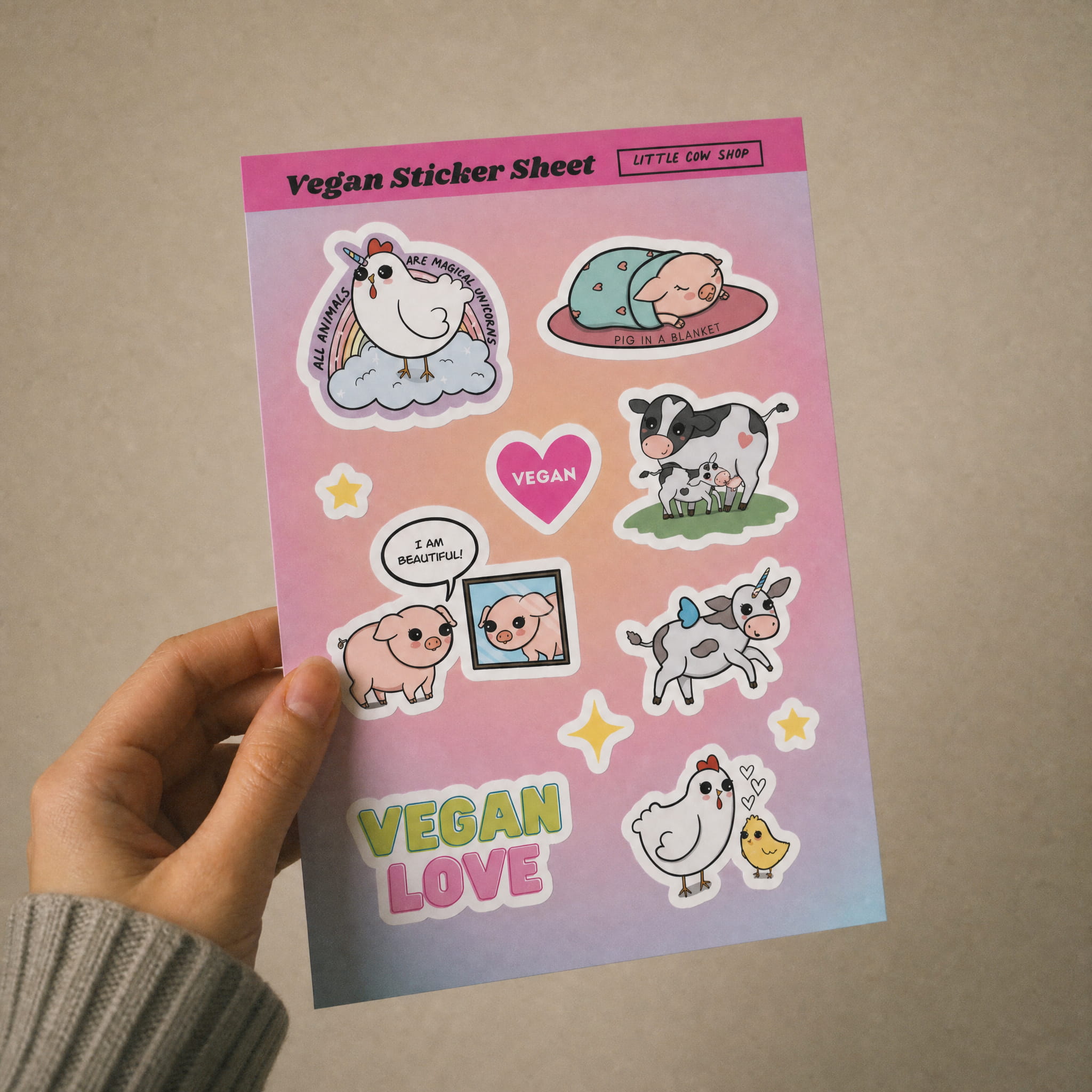 Vegan sticker sheet with Bo and Friends characters and 'Vegan Love' text held by a hand against a beige background