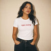 Woman wearing a white t-shirt with 'vegan mommy' text against a beige background