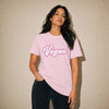 Woman wearing a pink t-shirt with 'Vegan' text against a beige background