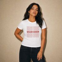 Woman wearing a white t-shirt with 'VEGAN QUEEN' text on a beige background